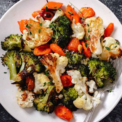 This recipe for oven-roasted vegetables with garlic brings out the natural flavors of cauliflower, broccoli, and carrots, enhanced by the deep, sweet taste of roasted garlic. Tossed in olive oil and seasoned with salt, pepper, and herbs, the vegetables caramelize beautifully in the oven. Whole garlic cloves are roasted alongside, becoming soft and sweet, then mashed and mixed in for a rich, garlicky flavor. Perfect as a side dish, salad addition, or healthy snack, this versatile and easy-to-prep Roasted Vegetables Salad, Carrots Cauliflower Broccoli, Broccoli Cauliflower And Carrots Recipe, Roast Cauliflower And Broccoli, Oven Roasted Broccoli And Carrots, Oven Roasted Broccoli Cauliflower And Carrots, Roasted Mixed Vegetables, Roasted Brocolli And Carrots, Best Roasted Vegetables