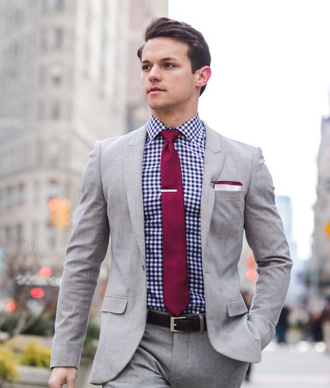 Sharp look!  Light grey men’s suit with gingham shirt and burgundy tie. Men’s Suit And Tie Outfit, Grey Suit Burgundy Shirt, Suit Tie Aesthetic, Light Grey Suit With Burgundy Tie, Spring Business Gray Suits, Suit And Tie Aesthetic, Grey Checks Suits For Men, Classic Gray Semi-formal Suit, Light Grey Suit Men