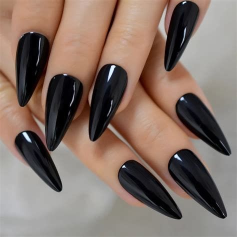 Long black press on nails have become increasingly popular in recent years, offering a convenient and affordable way to achieve salon-quality nails without the hassle of traditional manicures. With their sleek and elegant design, these nails are the perfect accessory for those who want to add a touch of glamour to their look. Whether you're attending a special event or simply want to feel more confident in your day-to-day life, long black press on nails are a must-have beauty item in 2023. Long Nail Beds, Salon Party, Nails Gradient, Wide Nails, Angel Nails, Nails Kit, Sharp Nails, Bears Nails, Goth Nails