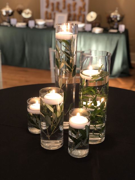 Safe Green Centerpieces, Emerald Flower Arrangement, Greenery And Candles Centerpieces, Olive Centerpiece Table Decorations, Emerald And Black Centerpieces, Deep Green Wedding Table Decor, Forest Green Centerpieces Wedding, Black Green Gold Wedding Receptions, Olive Green Centerpieces