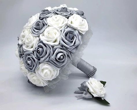 Customizable Silver and White Wedding Bouquet made with Real Touch Roses. Rhinestones are set on each rose. Handle is made up of Silver ribbon and tulle. Your choice of handle accessories. Great for modern weddings with an edgy twist on a classic wedding look. Matching Boutonnieres and Corsages available Available in four sizes:  Small 6" Toss/Mini Bouquet Medium 8" Bridesmaid Bouquet Large 10" Bridal Bouquet Ex-Large 13" Bridal Bouquet Color roses available: Red, black, gray, teal, royal blue, White And Silver Wedding, Roses Bridal Bouquet, White Silver Wedding, Modern Wedding Theme, Bridal Bouquet Bridesmaid, Color Roses, Modern Bouquet, Bouquet Bridesmaid, Bouquet Toss