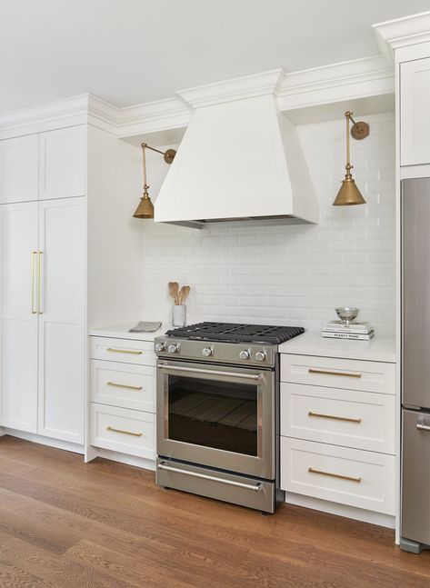 Kitchen Floating Shelves Wood, Wood Range Hoods, Kitchen Sconces, White Beveled Subway Tile, Floating Shelves Wood, Gorgeous White Kitchen, Grey Floating Shelves, Herringbone Tile Backsplash, White Wood Paneling