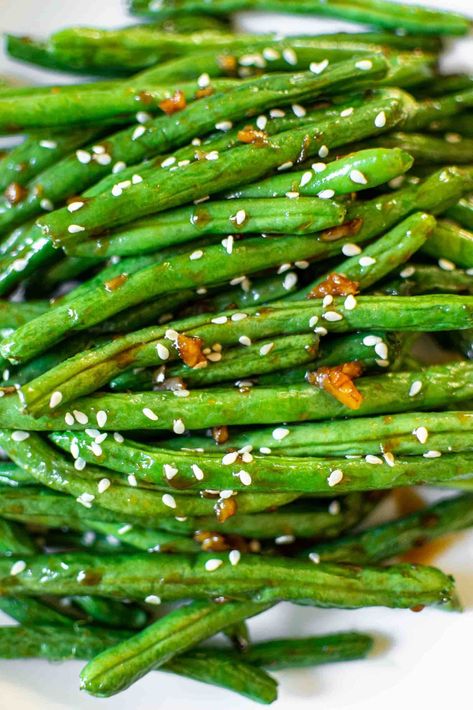 These Chinese Style Air Fryer Green Beans are so much like the takeout version, but a lot more healthy! Greens beans are crisped in the air fryer and tossed in a delicious, sticky garlic sauce! They are the perfect easy side dish for any Asian meal or great served on their own too! You can also. make these healthy green beans in the skillet if you don't have an air fryer. #airfryerrecipes #airfryer #greenbeans #easysidedish | www.getonmyplate.com Chinese Green Bean Recipes, Chinese Style Green Beans, Szechuan Green Beans, Chinese Green Beans, Air Fryer Green Beans, Asian Green Beans, Skillet Green Beans, Healthy Green Beans, Healthy Greens