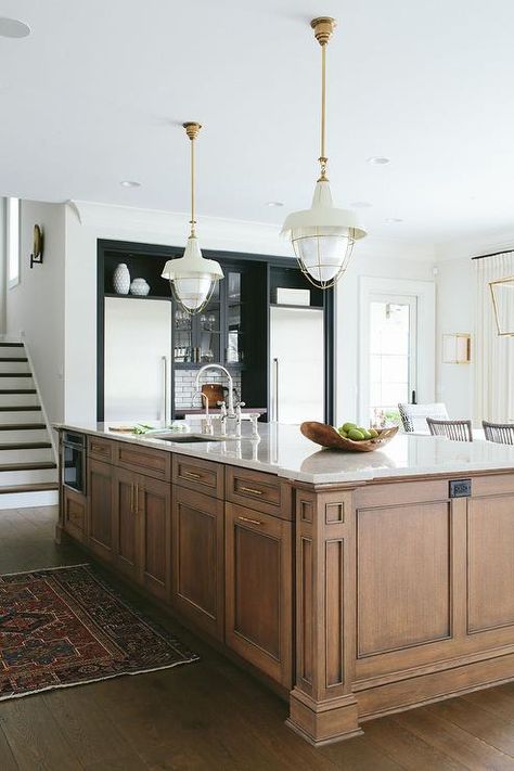 Amazing kitchen features a warm brown stained island adorned with brass hardware fitted with a stainless steel sink with two gooseneck faucets illuminated by Henry Industrial Hanging Lights. Stained Kitchen Cabinets, Transitional Kitchen Design, Classic Kitchen, Kitchen Farmhouse, Stunning Kitchens, Transitional Kitchen, Large Kitchen, Wood Kitchen, Beautiful Kitchens