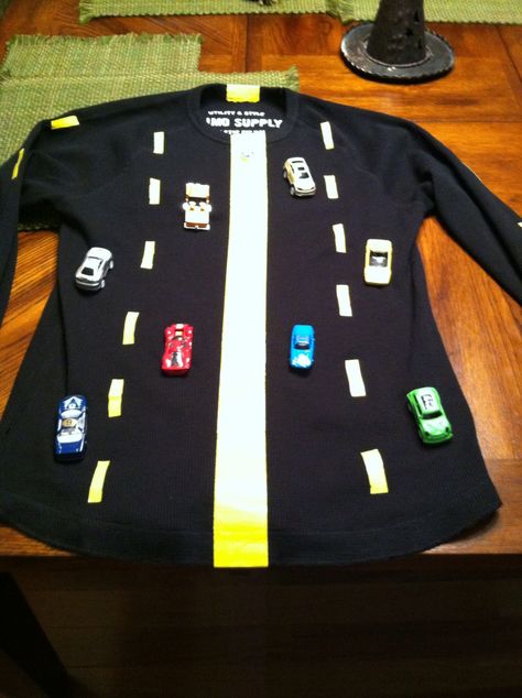 Road costume. Use yellow duck tape for the road lines. Sew cars onto a heavier fabric shirt, I used a thermal shirt. When I sewed the cars I wrapped the thread around the wheels between stitches. Fork In The Road Costume, Road Costume, Car Costume, Monkey Puzzle, Road Lines, Halloween Board, Fork In The Road, Duck Tape, 1 September