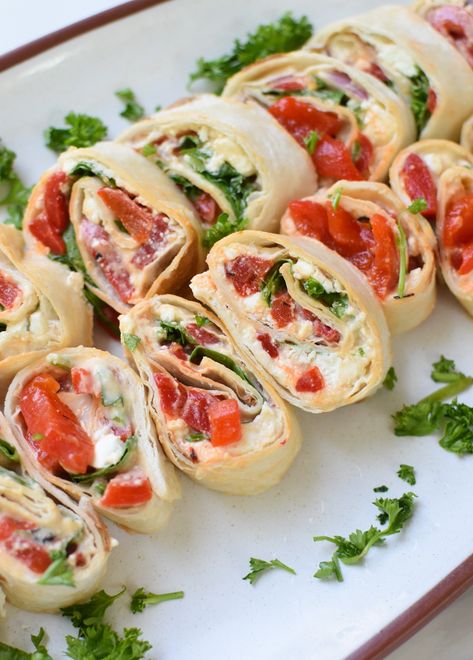 Mediterranean Pinwheels are the perfect finger food for your next outdoor gathering or kids lunches. Tortillas are filled with hummus, feta cheese, roasted red peppers, arugula, red onion and parsley, before being rolled and cut into the perfect bite sized appetizer. Your guests will love this colorful, light recipe! // A Cedar Spoon Mediterranean Pinwheels, Barbecue Party Food, Summer Potluck Dishes, Boat Snacks, Mediterranean Appetizers, Summer Appetizers, Summer Appetizers Easy, Summer Food Party, Bite Size Appetizers