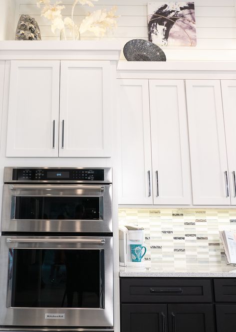 The straight lines of our Colonial cabinets and crown molding pair handsomely with the backsplash and shiplap of this tuxedo kitchen. Kitchen Cabinet Edge Trim, Above Cabinet Crown Molding, Crown Molding On Top Of Kitchen Cabinets, Straight Crown Molding Cabinets, Cabinets To Ceiling With Crown Molding, Modern Kitchen Crown Molding, Farmhouse Cabinet Crown Molding, Kitchen Backsplash Above Cabinets, Kitchen Cabinets With No Crown Molding