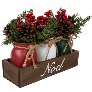 Full Dimensions (Varies Upon Shaping): 9" H x 10.94" W x 3.94" D Planter Dimensions: 5.25" H x 9.5" W x 2.5" D Plant Type: Pine Material: Glass, Wood, Plastic & Foam Color: Red, Green, Brown & White Care & Safety: Indoor Use Only Quantity: 1 Cultivate your space with festive faux florals, such as this Noel Berry & Pinecone Arrangement. This piece features three jars in the classic Christmas colors holding an assortment of faux foliage, berries, and pinecones. Around the neck of each jar, there is a jute bow, while the wooden box they sit in gives it a rustic look. The word "Noel" is written on the front in white script to spread holiday cheer. Display this at your next gathering along with complementary faux florals! Jar Christmas Decorations, Mason Jar Christmas Decor, Jar Christmas Decor, Mason Jar Christmas Decorations, Centerpiece Mason Jar, Birthday Candle Holder, Mason Jar Christmas, Chalk Paint Mason Jars, Christmas Flower Arrangements