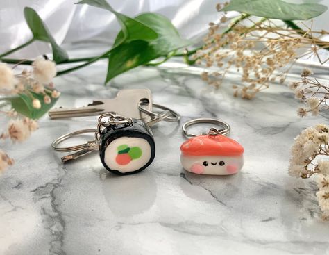 Handmade cute sushi polymer clay keychains. Ideal as a gift for a sushi lover or to keep for yourself. They come in 2 different variations. Maki or nigiri MATERIALS: - Colored polymer clay - Sealed with UV resin - Metal Ring Keychain Chain length: 6 cm Japanese Food Design, Polymer Clay Sushi, Clay Sushi, Polymer Clay Keychains, Anime Club, Cute Sushi, Nigiri Sushi, Clay Keychain, Clay Things