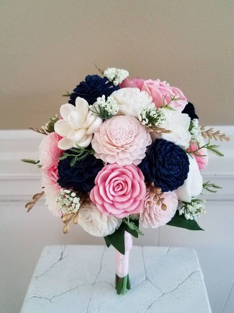 Sola flower bouquet in Soft shades of blush. Featuring a bright blush, medium blush and very delicate blush. The deep navy blue against the blush creates a sophisticated bouquet and the ivory keeps the colors balanced. The flowers are a variety of shapes and textures. Small accents of gold are added with queen Ann's lace and greenery. The accents add the finishing touches without taking away from the wood flowers. The handle is wrapped in a light blush satin ribbon with pearls. Bridesmaid bouque Prom Flowers Bouquet, Rose Floral Arrangements, Wood Flower Bouquet, Spring Wedding Bouquets, Blush Bouquet, Bridal Bouquet Flowers, Custom Bouquet, Prom Flowers, Bouquet Bridal