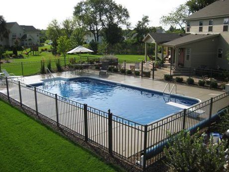 like ours... not too many bushes, fence has what looks like rocks at the edge... like this Fence Around Pool, Luxury Pools Backyard, Inground Pool Designs, Rectangular Swimming Pools, Inground Pool Landscaping, Rectangle Pool, Pools Backyard Inground, Swimming Pool Landscaping, Swimming Pools Inground