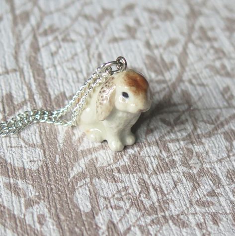 This cute bunny rabbit pendant is made from porcelain and is hand painted, then coated in a ceramic glaze.  Each pendant comes with a sterling silver plated chain which measures approximately 60.96cm/24" and comes beautifully presented in a gift box.   The pendant itself measures approximately 2cm/0.79inches in width x 2cm/0.79inches in height. Bunny Clothes, Cute Bunny Rabbit, Rabbit Jewelry, Spiritual Animal, Bunny Necklace, Porcelain Animal, Rabbit Pendant, Wooden Elephant, Animal Pendant