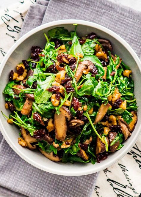 This Mushroom Arugula Warm Salad is all you need for a satisfying and delicious lunch. Toasted walnuts, perfectly sautéed shiitake mushrooms, dried cranberries and nutty baby arugula, all tossed with balsamic vinegar and olive oil. Simple and delicious! #mushroomarugulawarmsalad Mushroom Arugula, Cooked Arugula, Mushroom Salad Recipe, Vegetarian Mushroom Recipes, Warm Salad Recipes, Arugula Recipes, Mushroom Salad, Warm Salad, Easy One Pot Meals