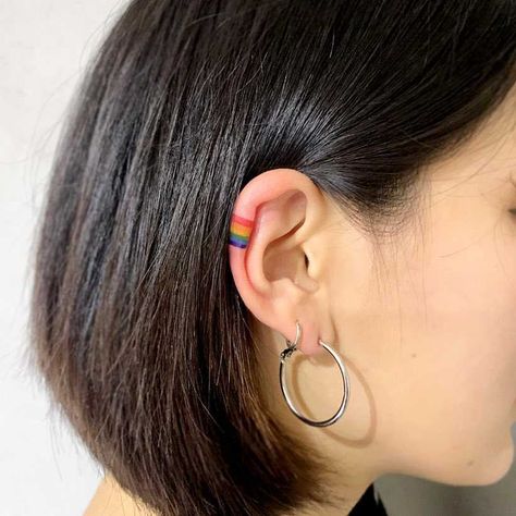 Tiny rainbow tattoo on the right ear Tattoos Ear, Gay Pride Tattoos, Tattoos Behind Ear, Tattoo Ear, Lgbt Tattoo, Rainbow Tattoo, Gay Tattoo, Pride Tattoo, Armband Tattoos