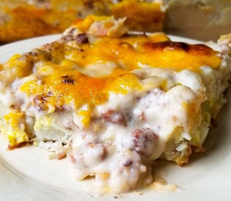 SAUSAGE GRAVY BREAKFAST CASSEROLE; a layered casserole of eggs, hash brown style potatoes, cheese, and sausage gravy; hits the spot every time! (A.K.A. HANGOVER CASSEROLE) Sausage Gravy Breakfast Casserole, Casserole With Hashbrowns, Sausage Gravy Breakfast, Breakfast Casserole With Hashbrowns, Gravy Breakfast Casserole, Sweet Breakfast Casserole, Vegetarian Breakfast Casserole, Ham Breakfast Casserole, Breakfast Casserole French Toast