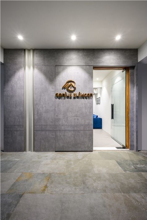 Genius Buildcon | Prangan Design | Surat - Interiorlover Office Main Wall Design, Commercial Entrance Door Design, Clinic Entrance Design Front Doors, Office Front Door Entrance, Office Main Door Design, Office Entrance Design Entryway, Home Front Wall Tiles Design, Office Main Door, Entrance Wall Design Front Entry