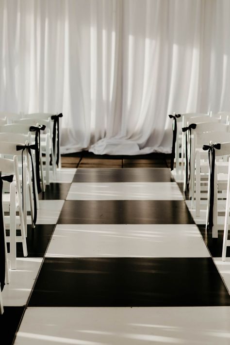 Black and White Wedding Dance Floor in Check Pattern Black And White Aisle Decor, Black White Minimalist Wedding, Bow Aisle Markers, Bows On Ceremony Chairs, Black And White Ceremony Arch, White Ceremony Chairs, Elegant Ceremony Decor, Wedding Aisle Bows, Black And White Wedding Aisle Decor