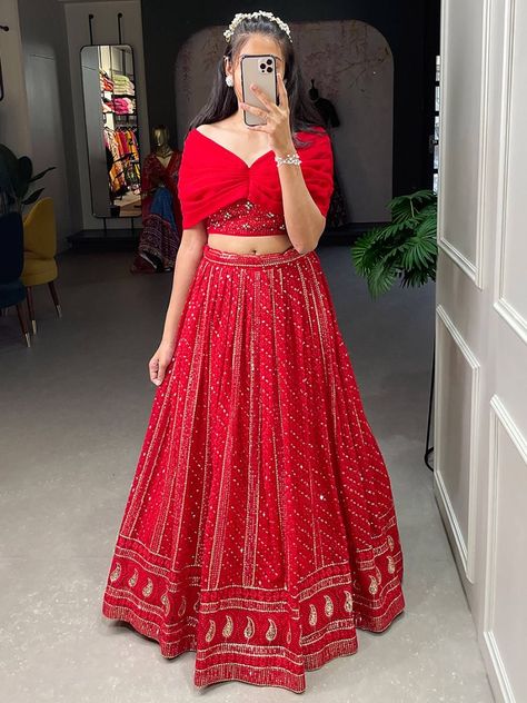 Introducing our appealing red sequins georgette party wear crop top lehenga! This exquisite outfit is designed to make you look absolutely stunning and steal the spotlight at any event. With its vibrant red color and intricate sequins and embroidery threadwork all over, this lehenga will showcase your impeccable taste and style. This lehenga is its red color georgette material, which adds a touch of elegance and sophistication to the overall design. The sequins and embroidery threadwork further Red Lehenga White Blouse, Red Traditional Outfits For Women, Red Blouse Designs For Lehenga, Simple Party Wear Skirt And Top, Trendy Crop Tops For Lehenga, Red Lehenga Blouse Designs, Red Traditional Dress Indian, Basic Lehenga, Reuse Bridal Lehenga