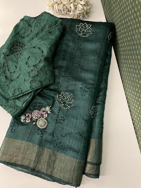 Immerse yourself in sophistication with our deep green handloom tussar saree. This exquisite creation boasts intricate hand embroidery, highlighting enchanting floral motifs with delicate French knots in a subtle shade of light green and glimmering golden zari border. The deep green hue adds an air of mystery to this handloom masterpiece, making it an ideal selection for those desiring elegance with a touch of enigmatic charm. The saree also comes with its own self blouse piece. Simple Border Saree, Light Green Saree, New Dress Design Indian, Pearl Blouse, Black Dessert, Tussar Saree, Simple Saree Designs, Desi Outfits, Green French