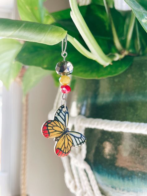 "add a little bling to your house plants, with these gorgeous plant charms!  *handmade by me, featuring glass faceted beads that catch the sun and look so pretty, adorned   with a 2 sided butterfly charm, one side is a realistic looking butterfly, the back side is gold with black swirl accents, they look stunning hanging from plants no matter which side you choose to display.  would be a perfect gift for yourself or that special plant lover in your life. *These work well on vining plants such as Plant Charms, Vining Plants, Beaded Suncatcher, Aesthetic Plant, Plant Accessories, Boho Butterfly, Plant Crafts, Plant Jewelry, Butterfly Decor