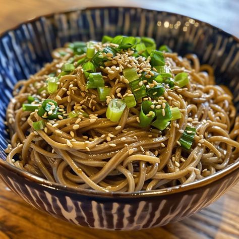 🍜 Cool down with Cold Soba Noodles and Peanut Sauce! #NoodleLovers 🍽️ Cold Soba Noodles with Peanut Sauce 🛒 Ingredients: Soba noodles: 200g Peanut butter: 2 tbsp Soy sauce: 2 tbsp Sesame oil: 1 tsp Scallions: chopped, for garnish Sesame seeds: for garnish 👩‍🍳 Instructions: Cook: Boil soba noodles, then rinse in cold water. Mix: Combine peanut butter, soy sauce, and sesame oil. Toss: Coat noodles with sauce, garnish with scallions and sesame seeds. 🌟 Perfect for a refreshing, quick meal an... Noodles With Sauce, Cold Soba Noodles, Noodles With Peanut Sauce, Peanut Sauce Noodles, Cold Soba, Instagram Recipes, Soba Noodles, Quick Meal, Trending Recipes