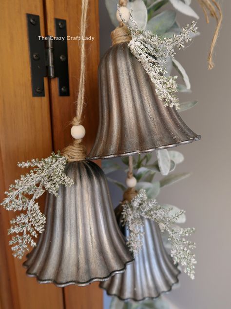 Make this DIY silver bell trio and transform plastic bells from the dollar store into high-end holiday decor Diy Jingle Bell Garland, Bundt Pan Christmas Crafts, Dollar Store Winter Decor, Vintage Christmas Store Displays, Antique Christmas Ornaments Diy, Jingle Bell Wreath Diy, Holiday Bells Decor, Large Bells Christmas Decor, Silver Bells Christmas Theme