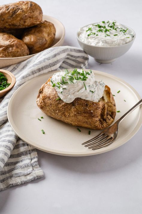 Baked Potatoes with Garlic Herb Sour Cream | Baked Bree Baked Potatoes Sour Cream, Sour Cream Baked Potatoes, Baked Potato With Sour Cream, Sour Cream Sauce For Potatoes, Potato Sour Cream Recipes, Baked Potato Sour Cream, Potato With Sour Cream, Baked Potatoes In The Oven, Make Baked Potatoes