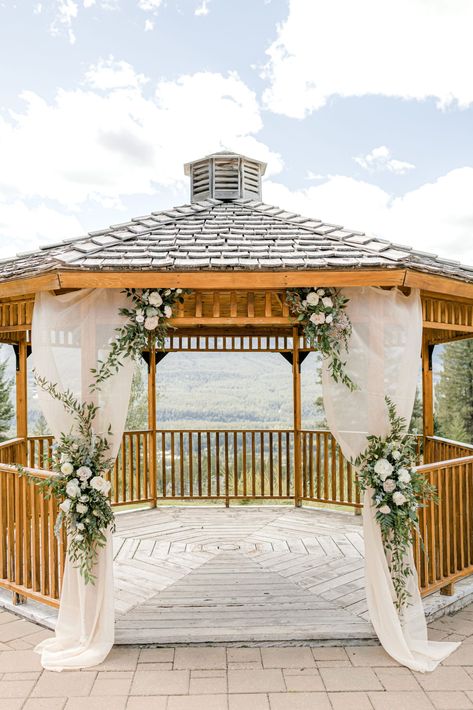 Outdoor wedding gazebo in Canmore, Alberta at Silvertip Resort. Blush and green florals on blush drapery, classic wedding ceremony inspiration. Wedding Gazebo Flowers, Summer Wedding Outdoor Ceremony, Outdoor Wedding Gazebo, Gazebo Wedding Ceremony, Mountain Portraits, Classic Wedding Ceremony, Gazebo Wedding Decorations, Draping Decor, Canmore Wedding