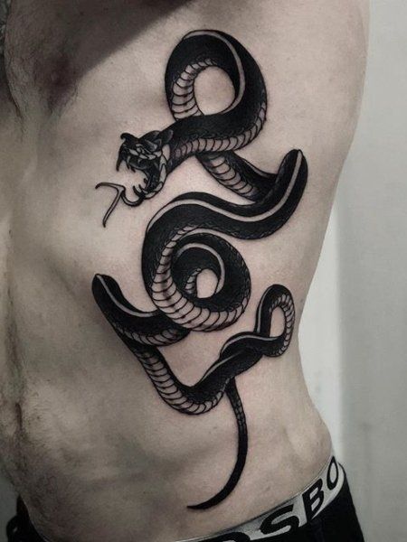 20 Cool Rib Tattoos for Men in 2021 - The Trend Spotter Dagger Tattoo Meaning, Snake And Dagger Tattoo, Snake Tattoo Meaning, Japanese Snake Tattoo, Cage Tattoos, Tattoo Snake, Spinal Fusion, Tattoo Dotwork, Ribcage Tattoo