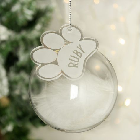 Sassy Bloom are pleased to present this white feather pet Christmas bauble  This feather glass bauble with paw print tag will make a stunning addition to the Christmas tree.The acrylic tag can be personalised with a pets name up to 9 characters long.Personalisation will appear in fixed uppercase.Each glass bauble is filled with a delicate white feather, which will look great hung on any Christmas tree!Please note these are handmade so there may be some slight imperfections such as small water ma Personalized Pet Memorial, Special Symbols, Xmas Tree Decorations, White Feather, Christmas Tree Baubles, Glass Bauble, Personalized Glass, White Feathers, Glass Christmas Tree