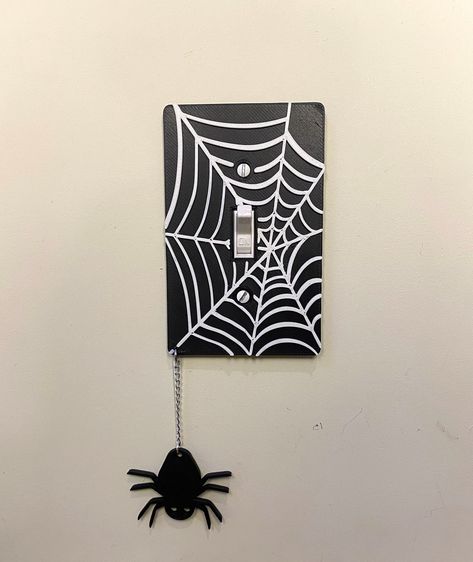 These are 3D-printed light switch covers, designed by me!  They are all made to order so allow up to 2 weeks of processing time. They're made from PLA, with several colors available!   :) The color shown in the photos is BLACK. All webs are WHITE you are picking one color for the background and spider. These are your average light switch cover, so please make sure they will fit in your space before you buy them!  They fit any standard single-gang toggle light switch cover. They measure about 4.7 Halloween Light Switch Covers, Painting On Light Switch, Gothic Light Switch Covers, Light Switch Decoration, Lightswitch Ideas Painting Easy, Light Switch Painting Ideas Aesthetic, Light Switch Covers Paint, Diy Lightswitch Cover Ideas, Painted Lightswitch Cover