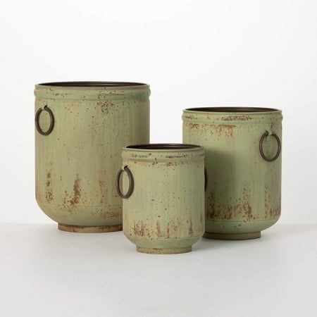 Enjoy the vintage charm of this timeless planter set. A great statement piece for any room of your home, this unique planter set features a beautiful olive-hued patina finish and unique design that will complement your decor style and accentuate your favorite spring botanicals. Perfect for the farmhouse or rustic cabin style. Size: 10inchL x 9.5inchW x 12inchH, 8.5inchL x 8inchW x 10inchH, 7.75inchL x 7.25inchW x 7.75inchH.  Color: Green. Planter Design, Unique Planter, Green Metal, Planter Stand, Metal Planters, Cabin Style, Patina Finish, The Farmhouse, Seasonal Home Decor