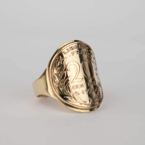 ARCHED BRASS SIGNET RING, made from an authentic 20 Cent Marianne Franc coin from the 5th French Republic, in Brass in reverse version. Have this ring engraved: We offer the possibility of personalizing your ring by adding an engraving inside. Ask us! Choice of year based on our stocks. Details and Registration: 20 Cents and an ear of wheat, olive branch and the motto "LIBERTY - EQUALITY - FRATERNITY" and the YEAR. Dimensions: Coin diameter: ± 23.50 mm Ring body width: ± 26 mm Manufacturing: Each piece we create is carefully crafted by hand and entirely personalized to order in our workshop based in France, more precisely in the Marne department (51). Free Adjustment: You have 7 days from the date of receipt to request a size change for your ring, with a tolerance of +/- 2 sizes. Authentic Olive Branch, Men's Ring, Fraternity, Engraved Rings, Signet Ring, Women Rings, Jewelry Rings, Rings For Men, Brass