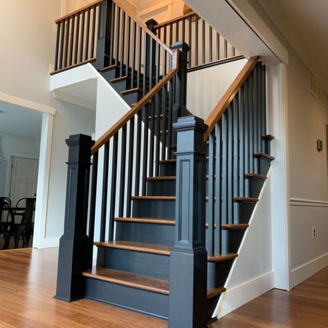 Oak stairs stained with Minmax English Chestnut with off-black wooden balusters and post. Black And Wood Stairs Stairways, Wooden Stairs Ideas Modern, Black And Oak Staircase Stair Railing, Black Stairs With Wood Steps, Staircase Black And Wood, Black Wooden Banister, Brown Stairs Black Railing, Black Wood Spindles Staircase, Stained Handrails Stair Railing