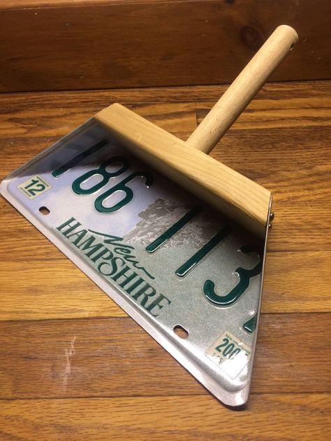 "License plate dust pan, What could be cooler!  You can hang this dust pan up on display or use it to clean up.  Shown is a New Hampshire license plate, this plate is mounted using screws to a cedar wood backing and a 1\" dia.  pine wood handle which is drilled for a string to be looped thru.  The wood is raw unfinished.   You can start by choosing a wood and finish variation below.   If you don't have a plate of your own, I can use one that I have in stock or locate something specific for you.  (Additional cost for locating a specific plate).  Or you can send me a plate that has special meaning to you and I can make it into a dust pan.  There are many different wood and finish options to choose from.  Some wood and finish options will help to enhance the look of your special plate.  You c Wood Projects That Sell, Small Woodworking Projects, Wood Shop Projects, Scrap Wood Projects, Dust Pan, Homemade Tools, Wooden Projects, Small Wood Projects, Cedar Wood