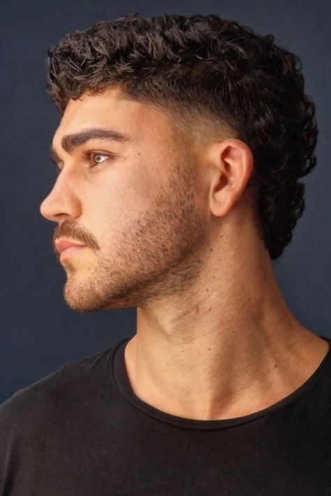 The Best 25 Modern Mullet Haircuts for Men (Detailed Gallery) | Heartafact Haircut For Man Curly Hair, Thick Mullet Men, Short Mens Curly Hair, Slightly Wavy Hair Men, Buzzcut Mullet Fade, Men’s Shaved Sides Haircut, Modern Muller Men, Medium Length Hair Men Mullet, Mid Mullet Fade