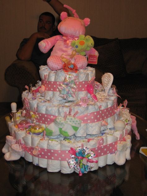 Diaper cakes are a trend that are unsurprisingly showing up at baby showers everywhere. They are a great gift to any expecting mother, and make a very interesting centerpiece or decoration at any shower. Making a diaper cake is not only giving the... Diaper Centerpiece, Diaper Cake Instructions, Diy Diaper Cake, Diaper Gifts, Diaper Cake Boy, Creative Baby Shower, Baby Diaper Cake, Homemade Baby Foods