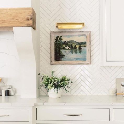 Add a pop of color and charm to your kitchen! Artwork In Kitchen, Herringbone Tile Kitchen, Herringbone White Tile, Cream Kitchen Walls, Herringbone Backsplash Kitchen, White Herringbone Backsplash, Cream Kitchen Tiles, White Herringbone Tile, Herringbone Tile Backsplash