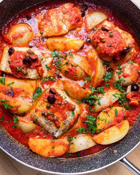 Baccala alla Napoletana is a traditional Italian dish that is best known in America for its appearance in the Feast of the Seven Fishes lineup on Christmas Eve. Salt cod, also known as baccala, is cooked in a garlicky tomato sauce with olives, capers, and potatoes. #baccala #italianfood #sevenfishes #seafood Baccala Recipes Italian, Italian Fish Dishes, Bacala Recipe, Italian Christmas Eve Dinner Traditional, Bacalao Recipe, Italian Fish Recipes, Cod Stew, Bacalhau Recipes, Feast Of The Seven Fishes