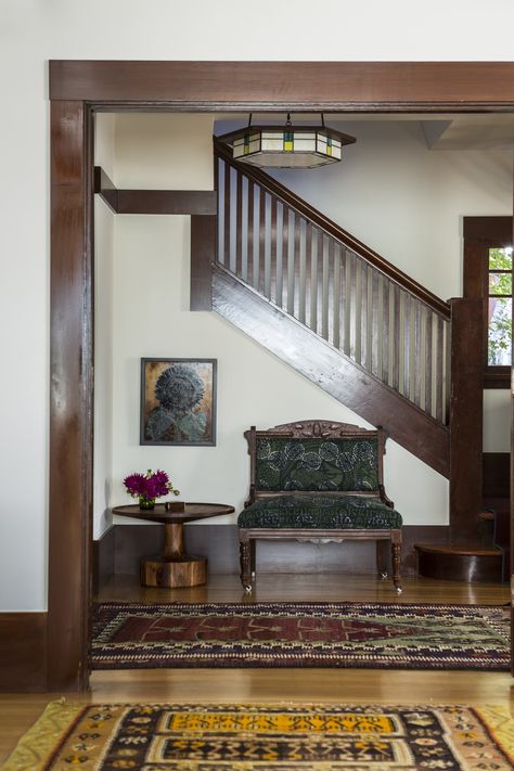 A vintage settee, antique rugs, a Blue Dot side table, and a custom chandelier lighten the mood in the house’s entry. Creamy White Walls, Reath Design, Craftsman Interior Design, Victorian Bohemian Decor, Craftsman Home Interiors, Victorian Interior Design, Berkeley Homes, Alternative Seating, Dark Trim