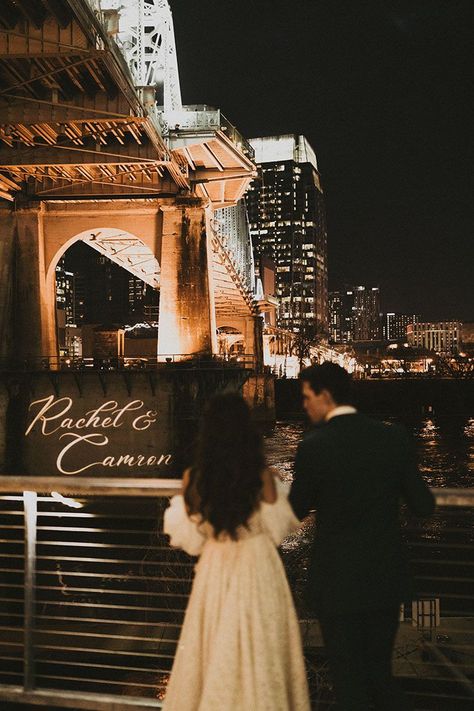 Bride and Groom Overlooking Downtown Nashville with their Names on the Pedestrian Bridge Bride And Groom Photography, New Year's Eve Wedding, Nashville Wedding Venues, Groom Photography, New Years Eve Weddings, Downtown Nashville, Bridge Building, Future Wedding Plans, Future Mrs