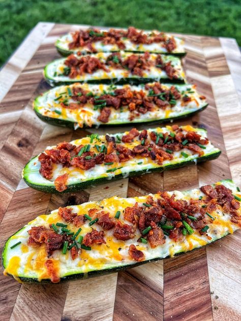 Make your vegetables even tastier with these delicious zucchini popper boats from Bear Mountain ambassador Kevin Anderson with @meat_thirty.  Prep time: 10 minutes  Cook time: 20-30 minutes   Ingredients:  -3 zucchinis (will make 6 boats)   -6 strips or a half package of bacon diced  -1 block of cream cheese  -Half cup shredded cheddar jack cheese  -2 jalapeños diced  -2 tbsp Garlic & Herb Seasoning & Rub from Rainier Foods   -Big pinch of chives  -Bear Mountain Gourmet BBQ Pellets    ... Smoked Zucchini, Zucchini Smoker Recipes, Bbq Zucchini Boats, Smoked Zucchini Boats, Smoked Zucchini In Smoker, Jalapeño Popper Sausage Boats, Zucchini Poppers, Zucchini Boat Recipes Ground Beef, Healthy Smoker Recipes