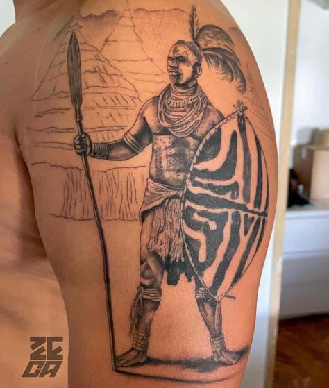 Shaka Zulu Emblem Tattoo African Related Tattoos, African Leg Tattoo, African Gods Tattoo, Zulu Tattoo Ideas, African Art Tattoo Ideas, Zulu Shield Tattoo, African Theme Tattoo, Mansa Musa Tattoo, African Warrior Tattoo For Men