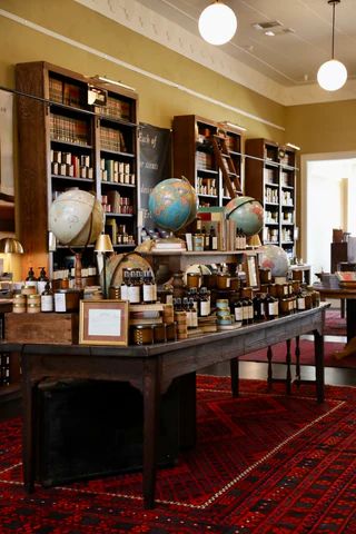 Mercantile Store Ideas, Romance Bookstore, Apothecary Design, Laurel Mercantile, Olive Plant, Library Bookcase, Candle Store, Buy Candles, One Candle