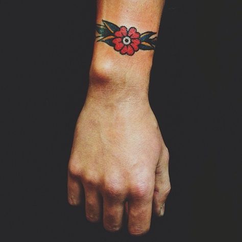 Bracelet Tattoo Traditional, American Traditional Cuff Tattoo, Traditional Wrist Cuff Tattoo, Wrist Tattoos Traditional, American Traditional Wrist Tattoo, Modern American Traditional Tattoo, Traditional Wrist Tattoo, Desert Flower Tattoo, Traditional Tattoo Wrist