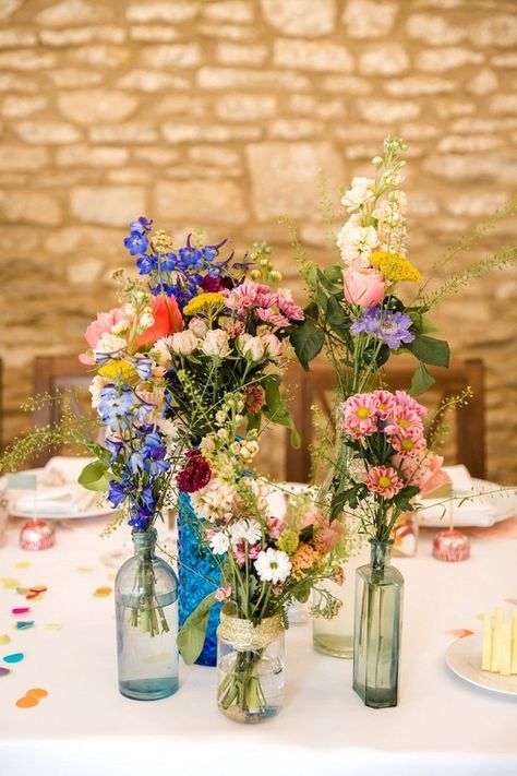 mixed bottles and wildflower wedding centerpiece ideas Wildflower Wedding Centerpieces, Wildflower Centerpieces, Wildflower Wedding Theme, Wedding Centerpieces Mason Jars, Laid Back Wedding, Budget Friendly Wedding, Bridal Shower Cakes, Wedding Table Flowers, Mason Jar Wedding