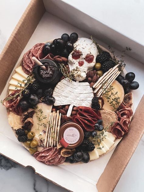 Summerween Charcuterie Board, Dark Cheese Board, Halloween Cheese Platter Ideas, Halloween Snack Platter Ideas, Pirate Themed Charcuterie Board, Skull Brie Cheese, Halloween Inspired Charcuterie Board, Autumn Grazing Board, Coffin Shaped Charcuterie Board