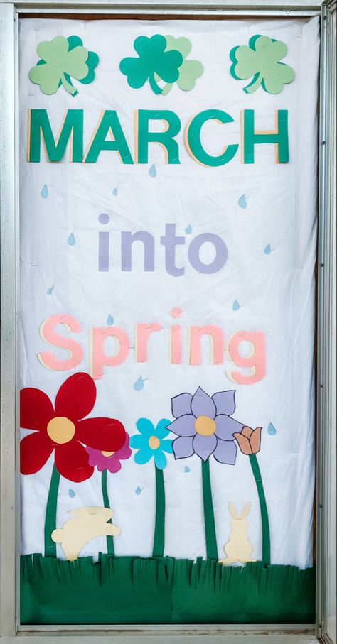 March into spring bulletin board with flowers, shamrocks and raindrops! Spring Office Decor Bulletin Boards, March Teacher Bulletin Boards, Prek March Bulletin Board, Spring Bulletin Board Ideas For School Free Printables, Spring Class Bulletin Board, March Decorations Classroom, Spring Time Art Preschool, March Preschool Bulletin Board Ideas, Spring Easter Bulletin Board Ideas