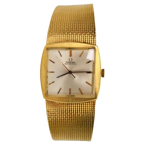 Bold, all in 18 Karat Yellow Gold, this sleek Omega Men's Dress Wrist Watch evokes the revered elegance and style of its era. Circa mid 1960's, this retro Omega beauty has an Swiss automatic movement #23162809. The satin polished gold square case #161922-222, measuring 29.6mm x 30mm presents a silver-toned face with gold match stick markers. The lush integrated 18 karat gold 7.5 inch mesh band bracelet is a substantial 1.36mm gauge and ranges in width from 24mm to 16.5mm. The time piece is finis Omega Gold Watch, Toned Face, Dress Box, Omega Man, Match Stick, Cool Gadgets To Buy, Band Bracelet, Watch Box, Luxury Watches For Men