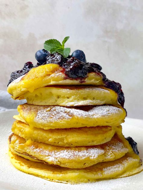 These delicious Lemon Ricotta Pancakes are the perfect way to start your day. Made from fluffy and tender ricotta cheese, these pancakes are light and fluffy and sure to please. Top them with a freshly made blueberry compote and lemon curd for a truly exquisite breakfast experience. Enjoy these pancakes with your family and friends and make memories that will last. Ricotta Lemon Pancakes, Using Lemon Curd, Exquisite Breakfast, Soufflé Pancakes, Brunch Party Recipes, Lemon Pancakes, Lemon Ricotta Pancakes, Brunch Items, Ricotta Pancakes